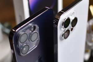 Close-up of iPhone 14 Pro Max in white and black highlighting camera features.