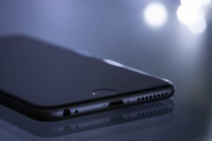 Close-up of a sleek smartphone with a blurred bokeh reflection, showcasing modern technology design.